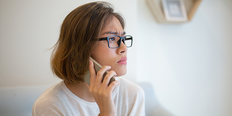 Woman talking on the phone and looking concerned