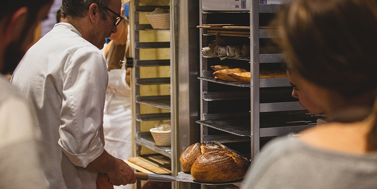 Man putting homemade bread away to cool