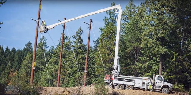 Bucket truck and employees working on electric power line