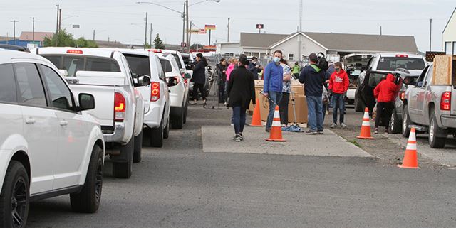 Cars lined up to pick up potato seedlings