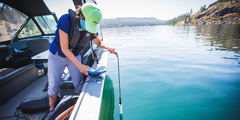 Woman on boat testing lake water