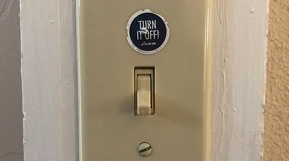 Light switch with a "turn it off" sticker