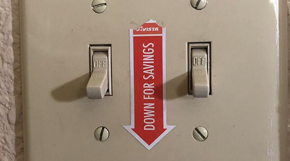 Light switch with a "down for savings" sticker