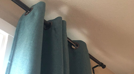 Closeup of curtain rod and drapes