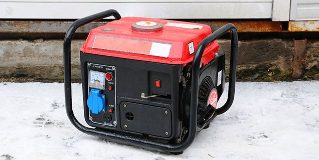 Portable electric generator outside with snow on the ground