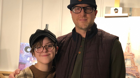 Father and daughter standing and smiling