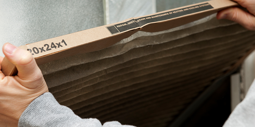 Hands holding a furnace filter