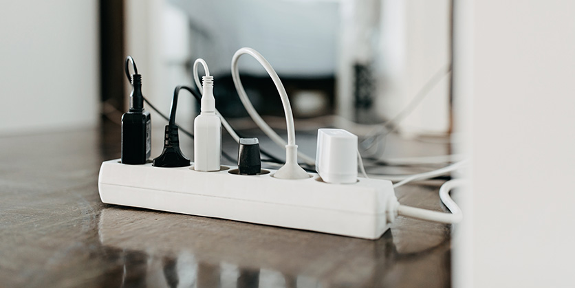 Surge protector power strip with chargers plugged into it