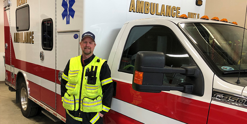 Man stands in front of ambulence