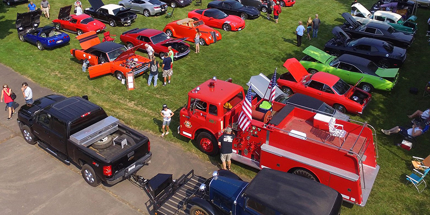 Cars lined up at an outdoor car show