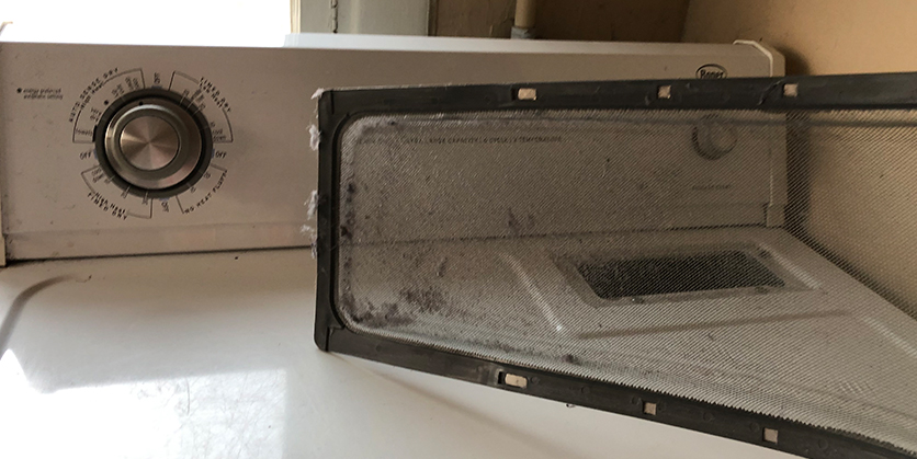 Closeup of a dirty dryer lint trap removed from the dryer