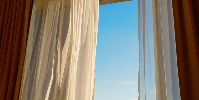 Closeup of a window with open curtains