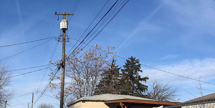 Power lines in front of a blue sky