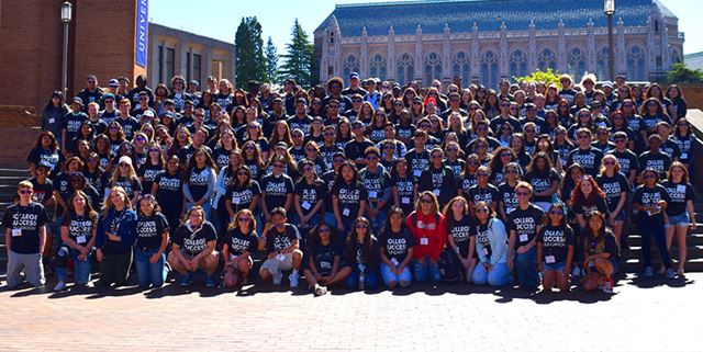 Large group of students wearing College Success Foundation tshirts posing and smiling for a group photo