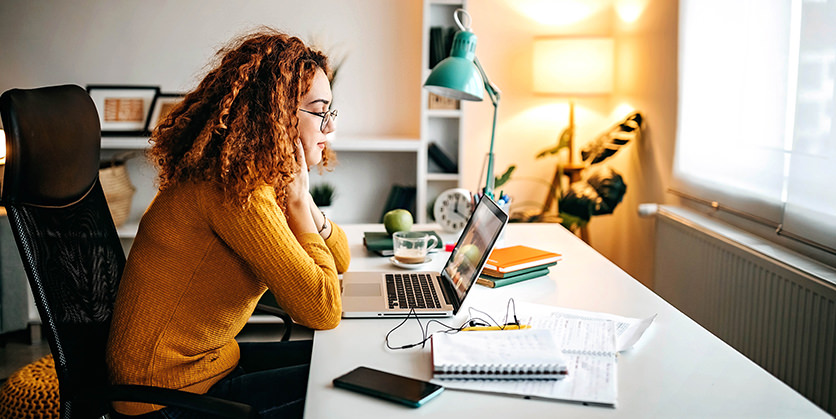 College student uses laptop to study in dorm room