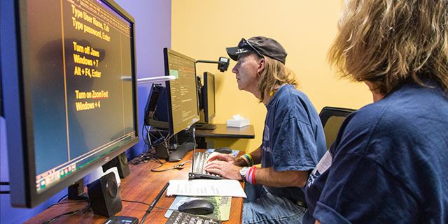 Person at Lighthouse for the Blind learning computer skills