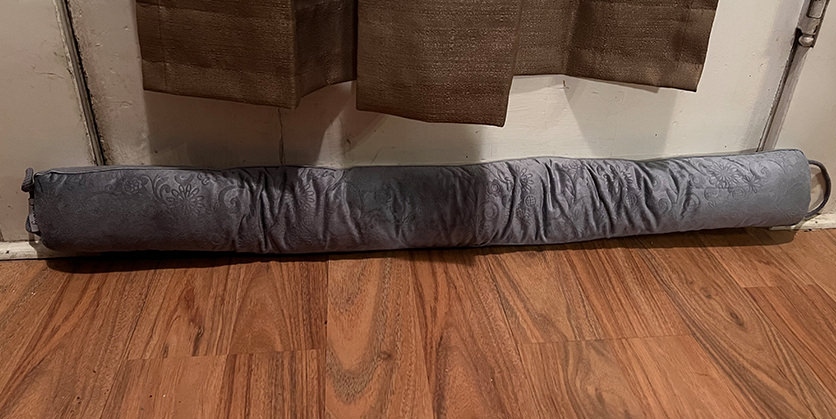 Fabric door snake at the bottom of a door