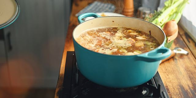 Preparing soup with fresh vegetables on the stove