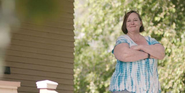 Lisa, an Avista customer, standing outside and smiling