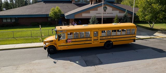 Electric powered bus in front of Loon Lake School