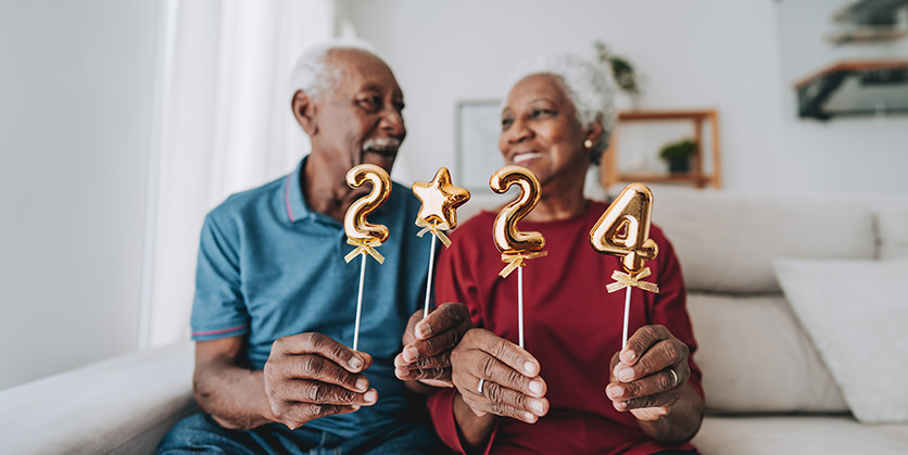 Senior couple holding the numbers 2024