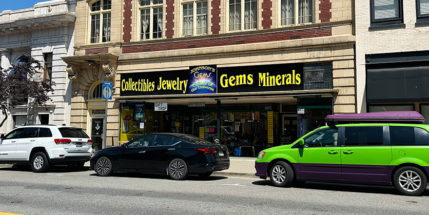 Brick building with a sign that says Johnson's Gems Center of the Universe Collectibles Jewelry Gems Minerals