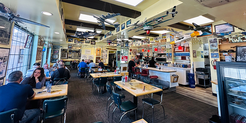Inside Skyway Cafe, a diner with groups of people sitting at tables