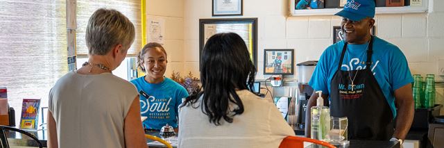 Two people chat with employees of Fresh Soul Restaurant in Spokane, WA.