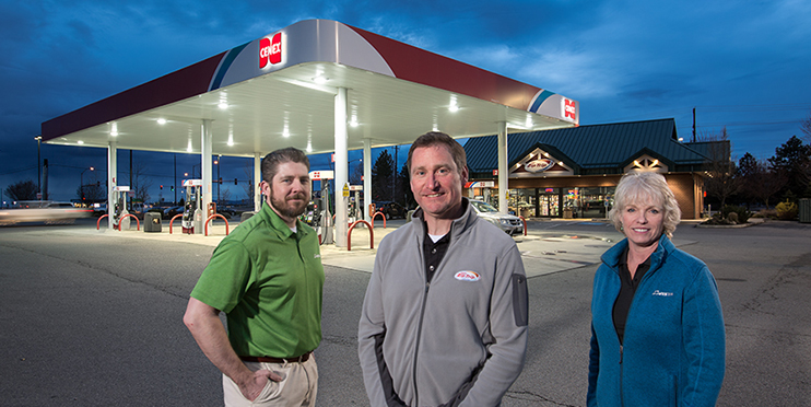 Two men and a woman standing in front of Cenex