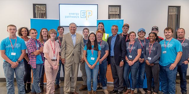 Gov. Jay Inslee with high school students smiling