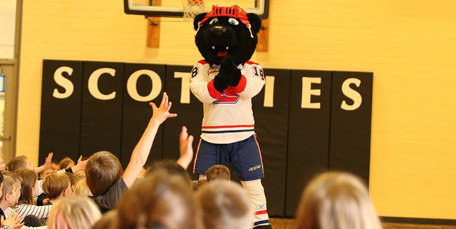 Boomer the Bear mascot and elementary school children