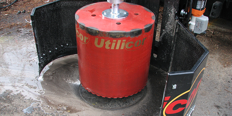 Boring rig sawing a circular cut in pavement