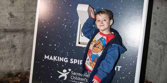Little boy flipping giant light switch