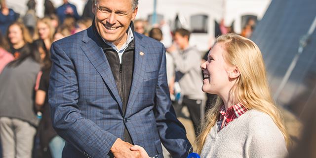 Man smiling with student