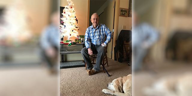 Older man with yellow lab dog
