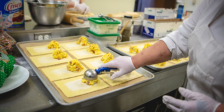 Person in a kitchen scooping food