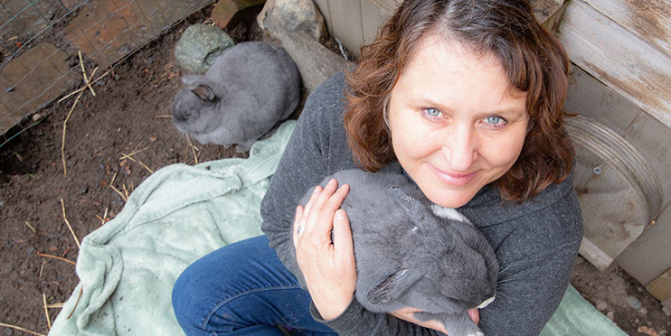 Woman holding gray rabbit