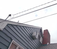 Overhead power lines connecting to house