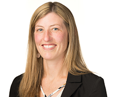 Brit, an account executive at Avista, smiles in front of a white background