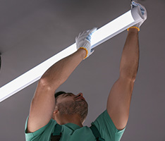 Man installing lighting at a business