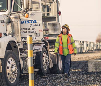 Woman walking towards oversized load truck