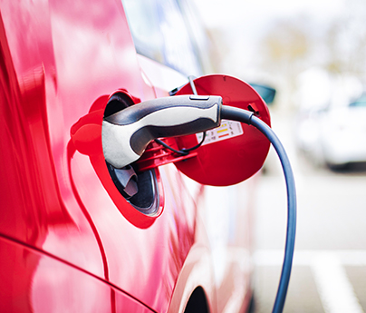 Closeup of an electric vehicle charging on a street
