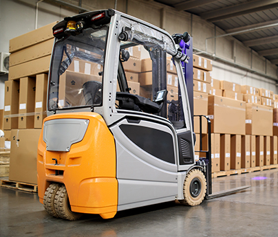 Electric fork lift in a warehouse
