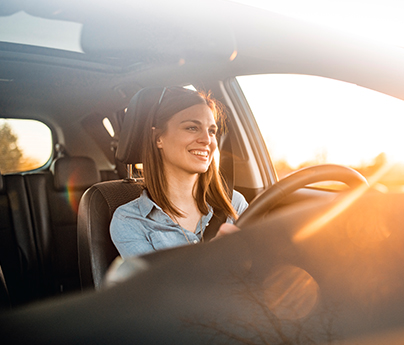 Closeup of a woman smiling while driving an electric vehicle