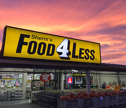 Sherm's Food 4 Less building and sign in front of a sunset sky