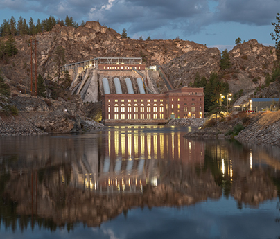 Avista dam with a blue cloudy sky and reflection in the water.